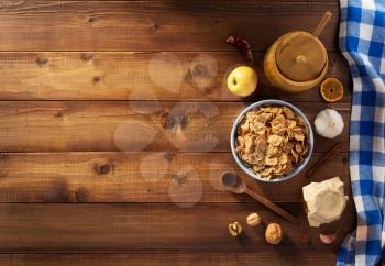 cereal flakes and healthy food on wooden background
