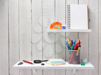 school supplies and tools at wall wooden shelf