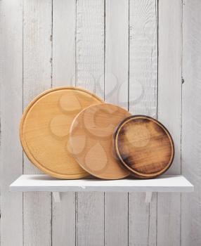 pizza cutting board at shelf on  wooden background