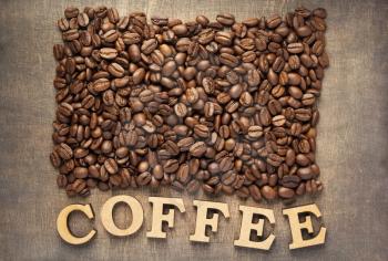 coffee beans on wooden table background, top view