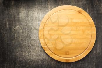 cutting board at old wooden table, top view