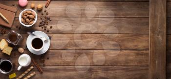 cup of coffee and beans on wooden background table, top view