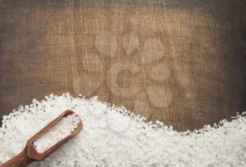 sea salt spice on wooden table background, top view