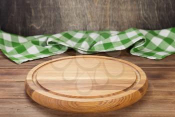 pizza cutting and napkin tablecloth board at rustic wooden table, in front plank background