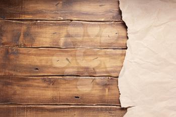 wrinkled or crumpled paper at wooden background texture