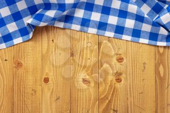 cloth napkin at old wooden board table background, top view