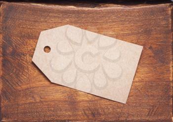 paper tag price at aged wooden background texture surface
