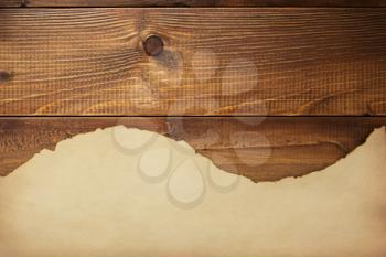 old retro aged paper parchment  at wooden background