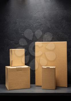 cardboard box on wooden shelf black background surface