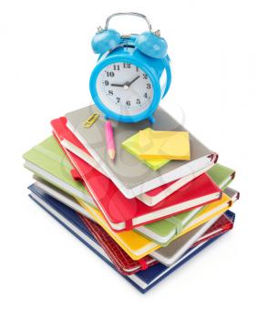 notebooks and alarm clock isolated at white background