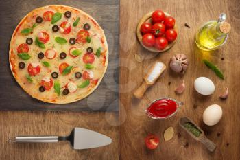 margarita pizza and food ingredients at wooden table, top view