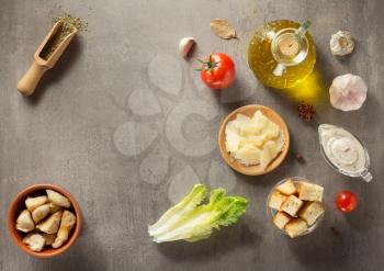 caesar salad ingredients at stone  table background