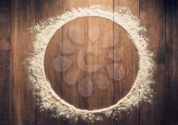 flour powder on wooden background