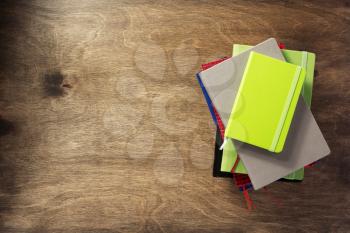 colorful notebook at wooden background texture