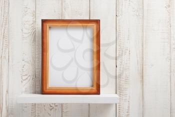 photo picture frame at white wooden shelf