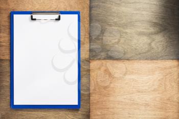paper clipboard at wooden background texture