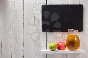 apple juice at shelf on wooden background