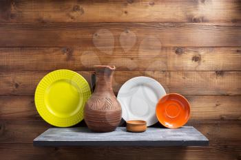 plate at kitchen wooden shelf at wall background