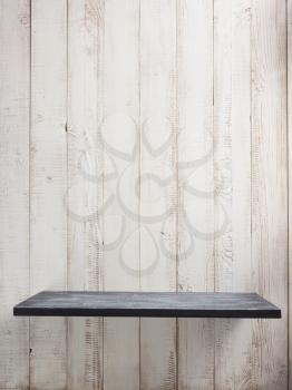 wooden shelf at white wall background texture