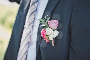 The man in a suit and with a buttonhole.