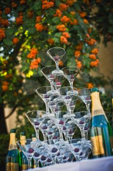 Table with glasses for champagne, cherry in glasses.