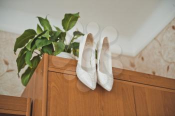 White shoes hang on a case door.