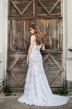Photo of the girl in a wedding dress on the street.