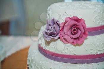 Big wedding cake with roses.