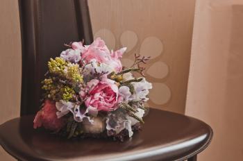 A bouquet of beautiful flowers on the chair.