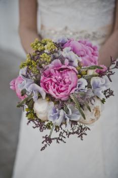 A bouquet of flowers in the hands of the bride.