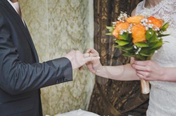 The process of putting on wedding rings.