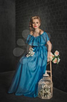 Studio portrait of the girl in a blue dress.