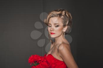 Portrait of the beautiful girl in a red dress.