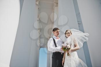 Newlyweds hugging on the background of the Church.