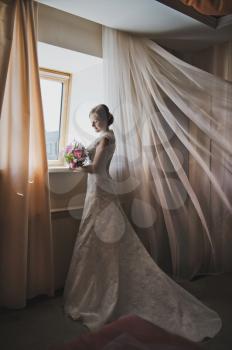 Portrait of a woman in long wedding dress.