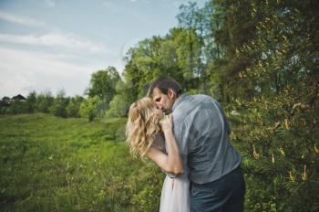 Newly-married couple in the wood about a tree.