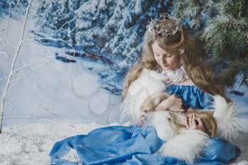 Portrait of the snow Queen in the winter woods.