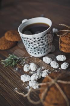 Coffee and cookies on wooden table.