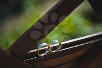 Precious ring lying on the windowsill out of wood.