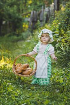 Child with a basket of fresh pastries.