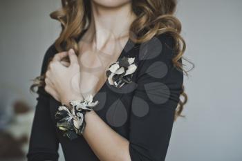 The corsage on the girls hand.