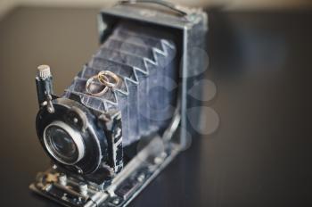 The ancient shabby camera on a table.