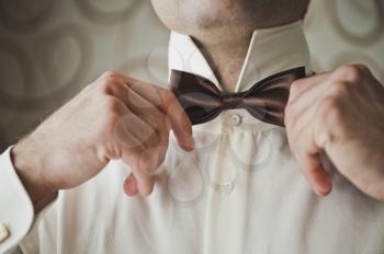 The process of donning the tie.