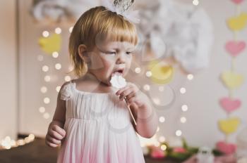 Portrait of a child with sweets at the feast.
