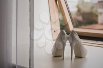 White shoes on the windowsill.