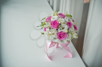 Bouquet lying in curtains on a window sill.