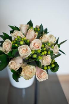 Bouquet from roses and other flowers on a table.