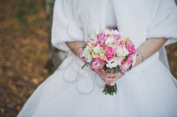 Bouquet of beautiful flowers in hands of the bride.