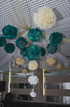 The ceiling of the celebration hall is decorated with paper balls.