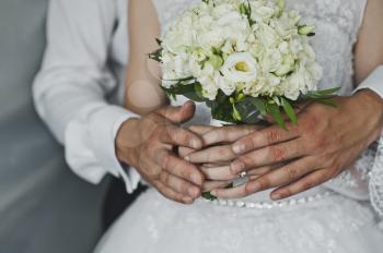 Mans and female hands hold wedding rings.
